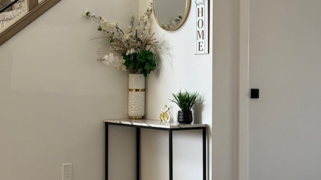 Stylish home entryway featuring a minimalist console table with decorative items.