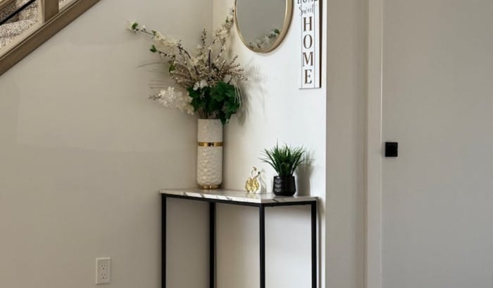 Stylish home entryway featuring a minimalist console table with decorative items.